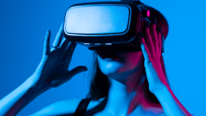 Female standing in a blue room, with VR headset on.